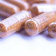 Photo of multivitamin capsules on white surface.